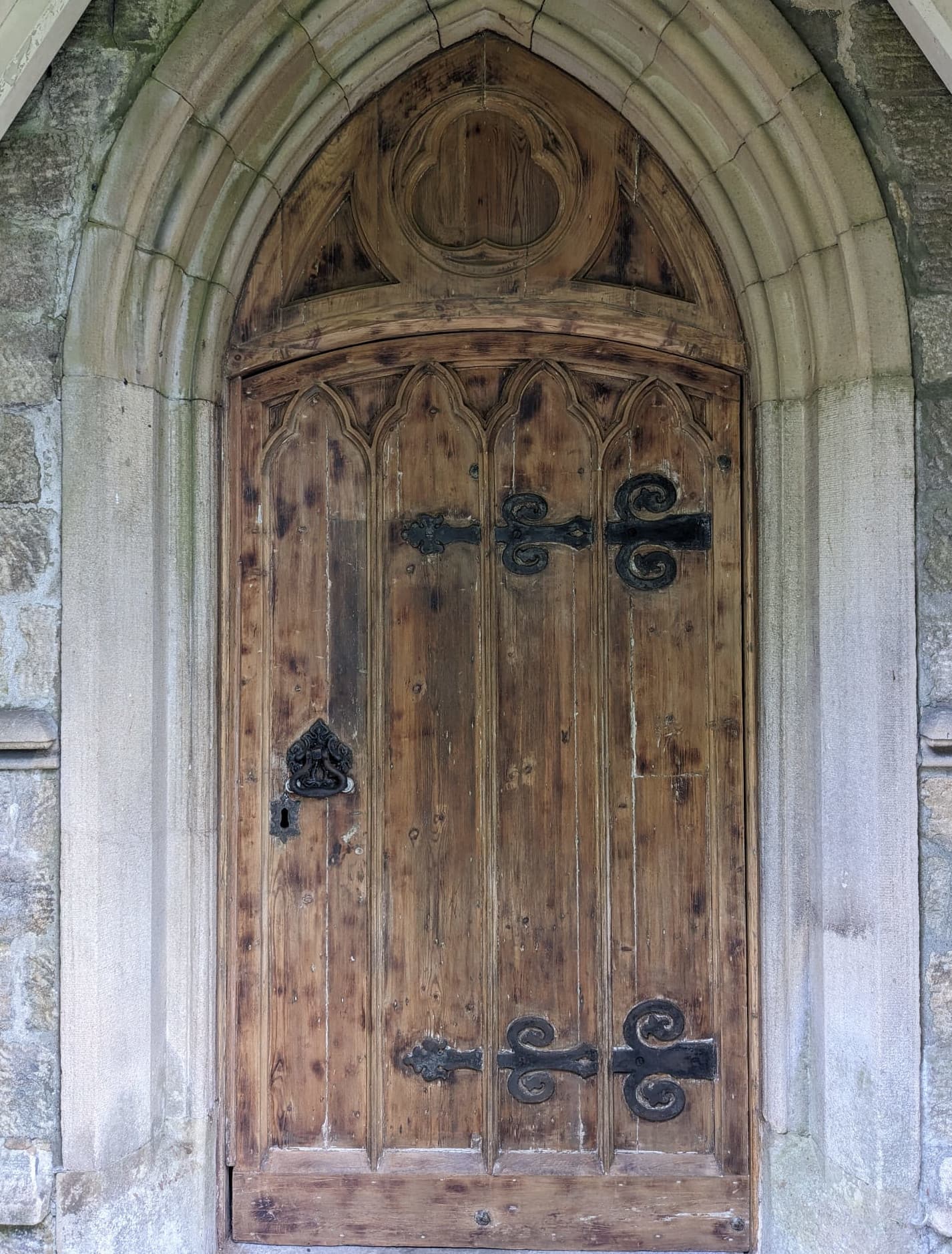 Church door before restoration - weathered and aged