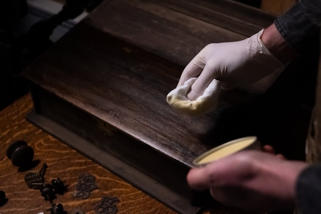 Hand-applying polish to wood surface